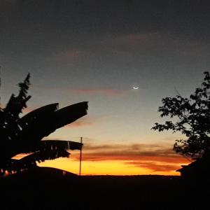 a silhouette of a plane in front of a sunset at Flat do Sossego 2 in Triunfo