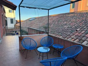 a patio with three blue chairs and a table at Sun Moon Venice Harrysclass in Venice