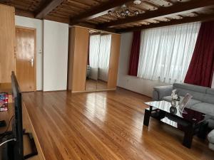 a living room with a couch and a table at Haus Ernestine in Sankt Urban