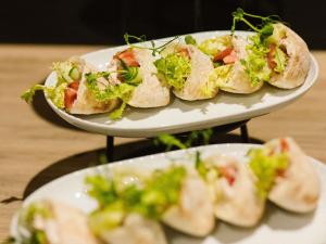 two plates of sandwiches sitting on a table at ibis Styles Bialystok in Białystok