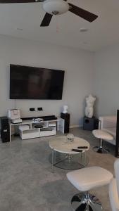 a living room with a flat screen tv and a table at Furnished Private Room in Las Vegas