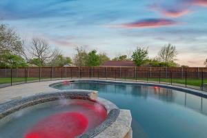 a swimming pool in a yard with a fence at Gorgeous 4BR Home with Huge Yard Pool in Denton