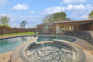 a swimming pool in a yard with a house at Gorgeous 4BR Home with Huge Yard Pool in Denton +28 photos