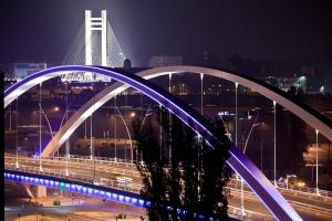 a bridge over a city at night with traffic at Hotel Yesterday in Bucharest