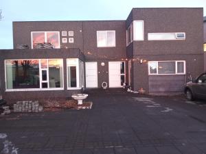 a brick house with a parking lot in front of it at Quiet, two bedroom apartment in Reykjavík