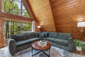a living room with a green couch and a table at Tamarack Lodge Tomahawk WI in Lake Tomahawk