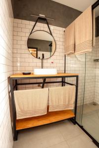 a bathroom with a sink and a mirror at Villa Container in the Wine Route in São Roque