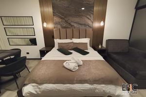 a bedroom with a large bed with two towels on it at Epic Suite 511 Premium Airport in Pereira
