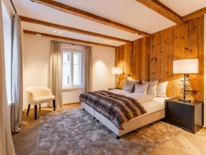 a bedroom with a large bed and a window at Villa Filzer in Kirchberg in Tirol