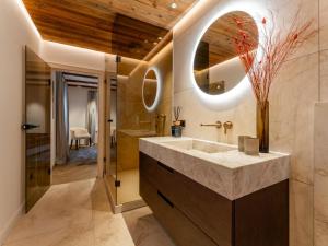 a bathroom with a large sink and a mirror at Villa Filzer in Kirchberg in Tirol +43 photos