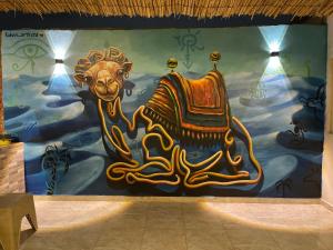 a wall with a painting of a camel on it at Farida Pyramid Boutique Hotel in Cairo