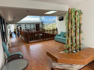a living room with a couch and a table at Flor y Canto Hotel in Matehuala