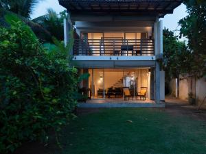 a house with a view of the outside of it at White parrot beach villa in Ambalangoda