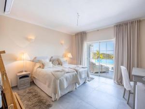 a bedroom with a bed and a view of the ocean at Private Bedroom in a Luxurious Villa, Budens in Budens +32 photos