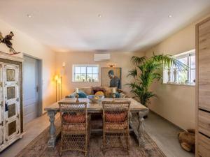 a dining room with a table and chairs at Private Bedroom in a Luxurious Villa, Budens in Budens