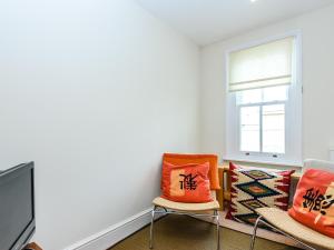 a living room with two chairs and a window at Lapwing in Yarmouth