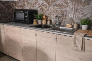 a kitchen with a microwave and a sink at leuca bis house in Lecce