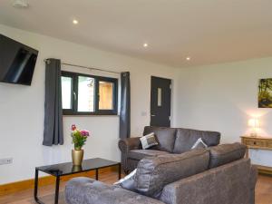 a living room with a couch and a table at Offa's Dyke Lodge - Uk10835 in Old Radnor