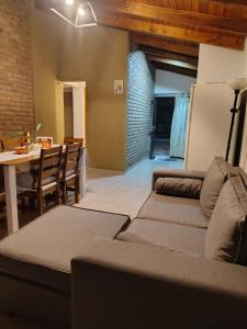 a living room with a couch and a table at Cabaña Quimey in Villa Rumipal