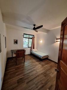 a room with a bed and a desk and a window at noemi apartments samara beach A-2 in Sámara +7 photos