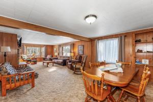 a large living room with a wooden table and chairs at Eagle Villa At Otter Cove in Eagle River