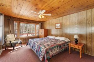 a bedroom with a bed and a ceiling fan at Eagle Villa At Otter Cove in Eagle River