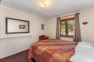 a bedroom with a bed and a window at Eagle Villa At Otter Cove in Eagle River