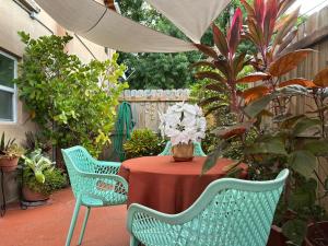 a table with a red table cloth and two chairs at Mermaid's Lighthouse in West Palm Beach