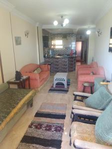a living room with couches and a fireplace at Charming blue see view apartment in Alexandria