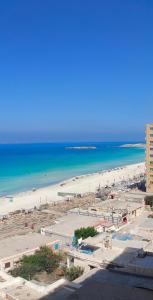 a view of a beach with people in the water at Charming blue see view apartment in Alexandria