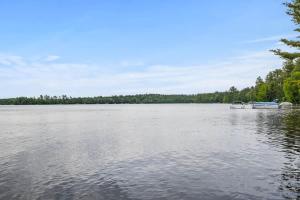 a large lake with a boat in the middle at Creekside Big St Germain Lake in Saint Germain
