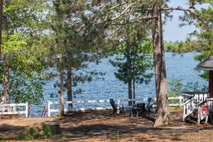 a table and chairs in front of the water at Loons Landing Legacy in Saint Germain +18 photos