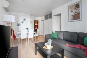 a living room with a gray couch and a table at Central 2BR Apt by Melbourne Central City Views in Melbourne