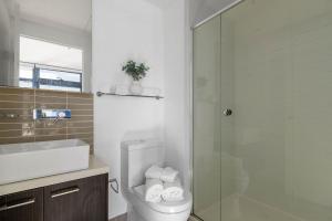 a bathroom with a toilet and a glass shower at Central 2BR Apt by Melbourne Central City Views in Melbourne +23 photos