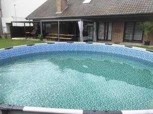 a large swimming pool in front of a house at Hani's Partyhaus in Verl