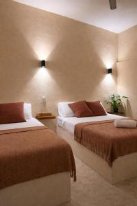 a hotel room with two beds in a room at Chulel Hotel Origen in Cedro +9 photos