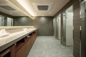 a bathroom with two sinks and a large mirror at Stay Ohana in Seoul +34 photos