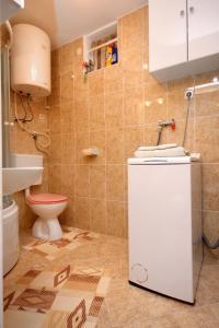a bathroom with a toilet and a sink at Apartment Rogacic 2460b in Vis