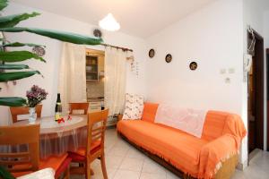 a living room with a bed and a table and a dining room at Apartment Rogacic 2460b in Vis +18 photos