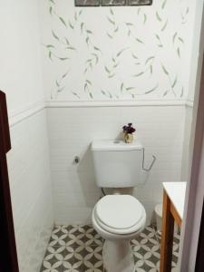 a bathroom with a white toilet and a white wall at Habitaciones La Apacheta - El Mollar in Tafí del Valle