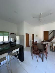 a living room with a dining room table and chairs at Suri Homestay, Taiping in Taiping