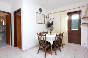 a dining room with a white table and chairs at Apartment Rogacic 2460a in Vis +22 photos