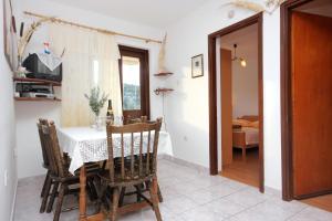 a dining room with a table and some chairs at Apartment Rogacic 2460a in Vis
