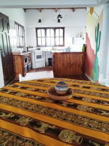 a large room with a large bed in a kitchen at Habitaciones La Apacheta - El Mollar in Tafí del Valle