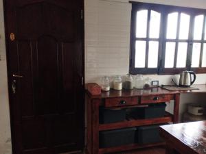 a kitchen with a wooden table with jars on it at Habitaciones La Apacheta - El Mollar in Tafí del Valle +16 photos