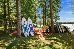 a group of surfboards are lined up next to trees at Whispering Waters Bayview Resort Cabin 4 in Saint Germain