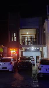 a group of cars parked in front of a building at DIENG GHUZY HOUSE syariah family room 3 kamar in Wonosobo