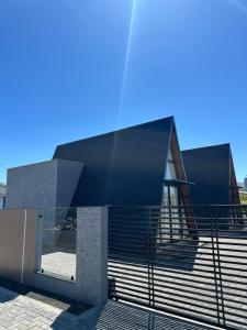 a building with a black roof and stairs at Âmbar Chalés in Ametista do Sul