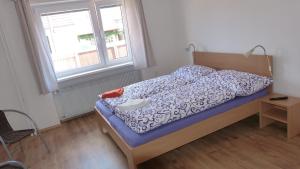 a bedroom with a bed and a window at Penzion Pod Jáchymem in Dobrá Voda