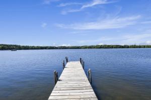 a wooden dock in the middle of a lake at Bayview Resort Sandy Shores Cabin 3 in Saint Germain